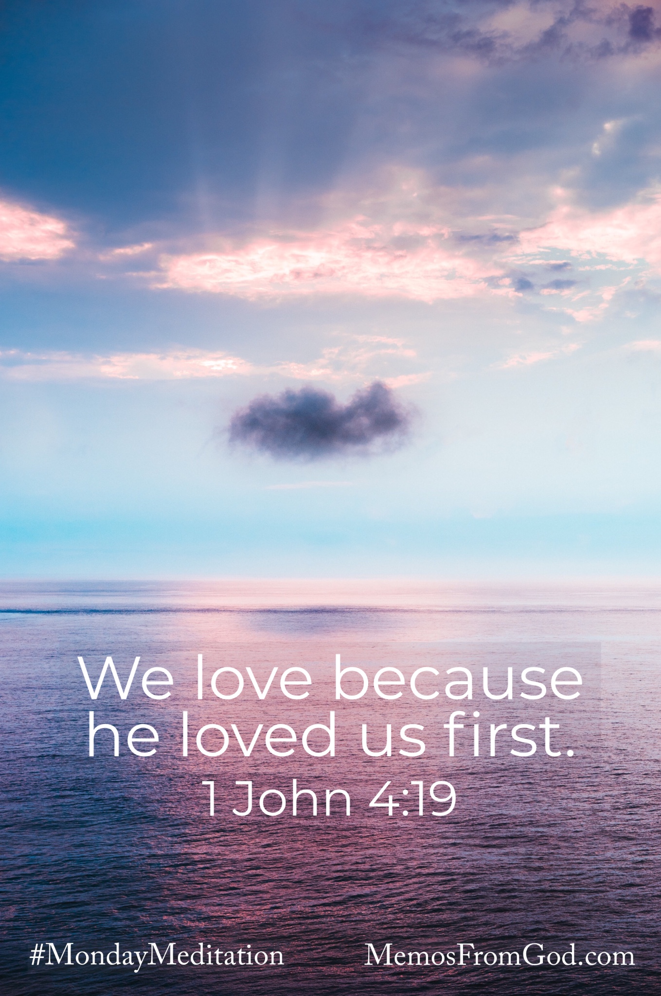 A body of water reflecting the blue and purple sky with the shadow of one small, dark cloud below the rays of sun shining through a brighter cloud. Caption: We love because he loved us first. 1 John 4:19